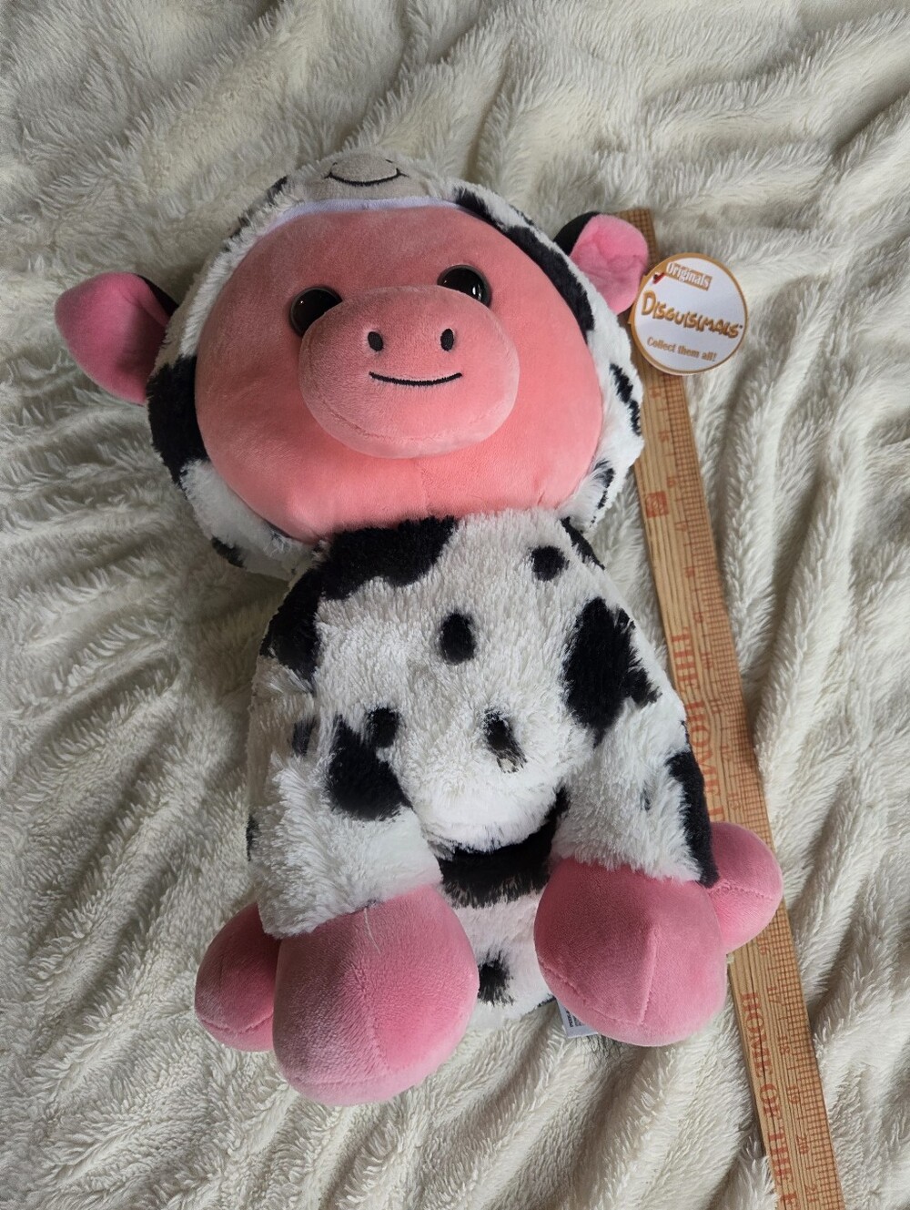 Disguisimals "Mooeey the Pig" plush toy dressed in a black-and-white cow suit